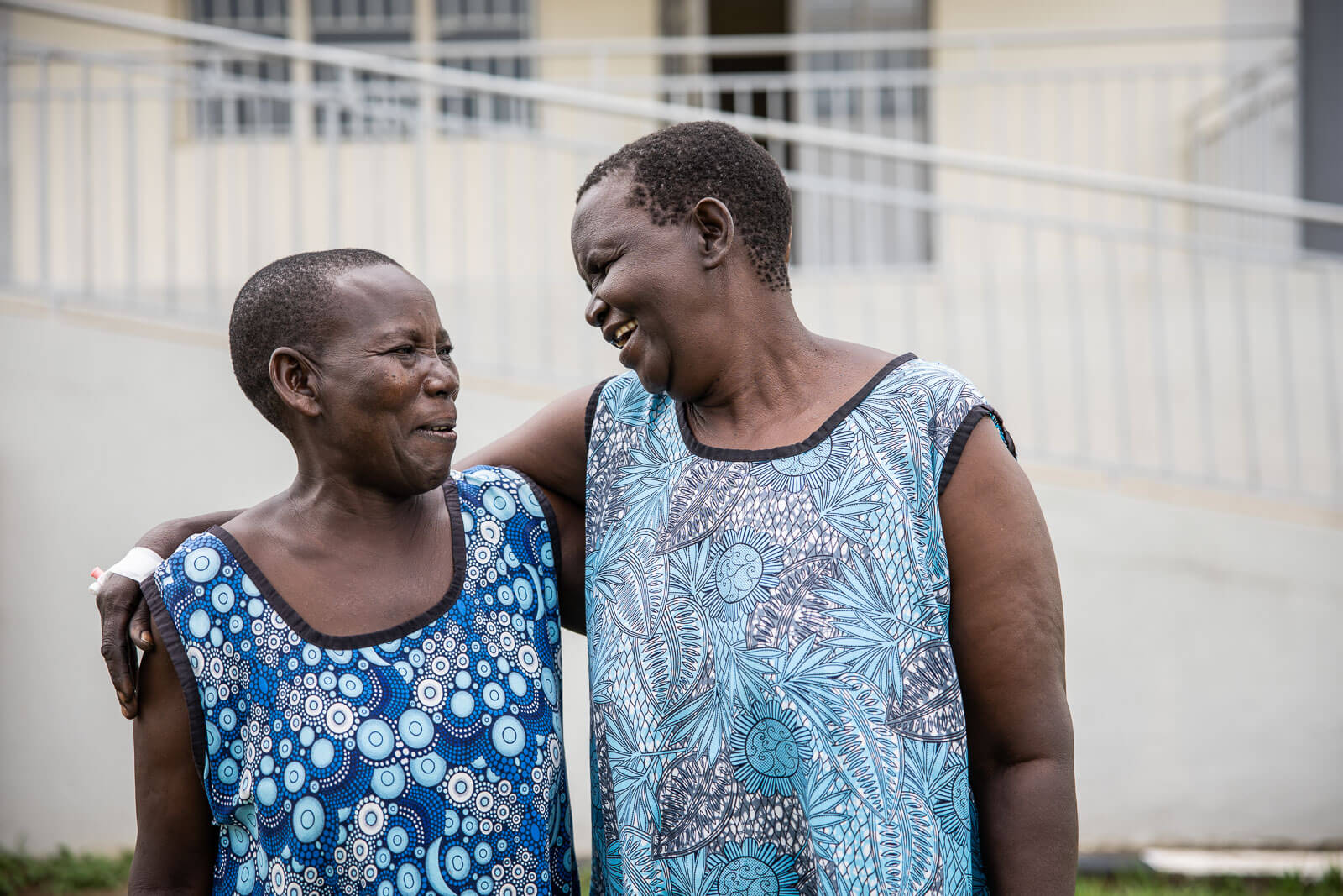 Two women smiling and embracing after receiving support through TERREWODE