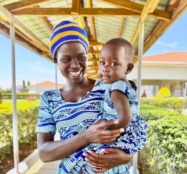 Fistula survivor holding baby outside Fistula survivor holding baby outside of Terrewode Maternity