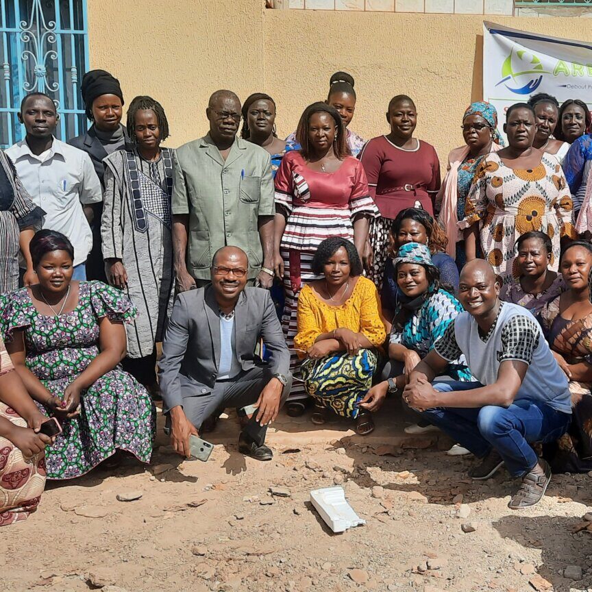 Group photo1 ARENA staff, healthcare advocates, and community members pose together outside a building in Burkina Faso.