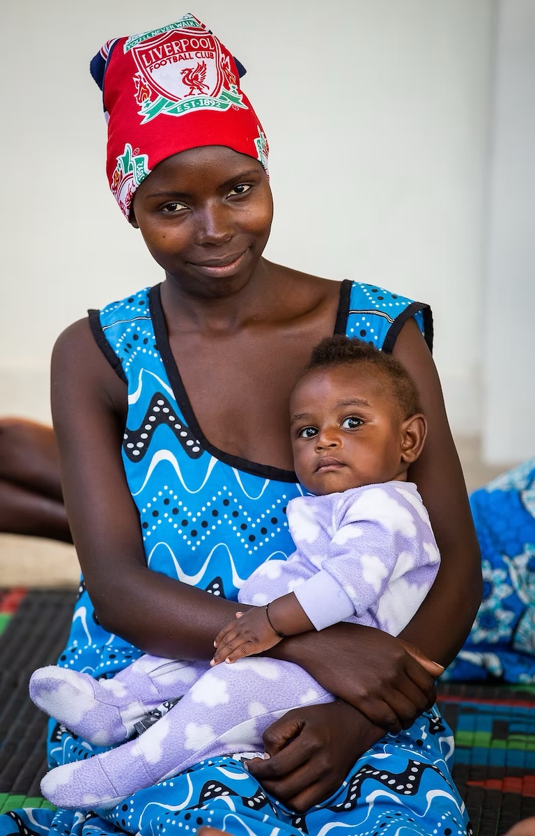 Fistula survivor hugging baby